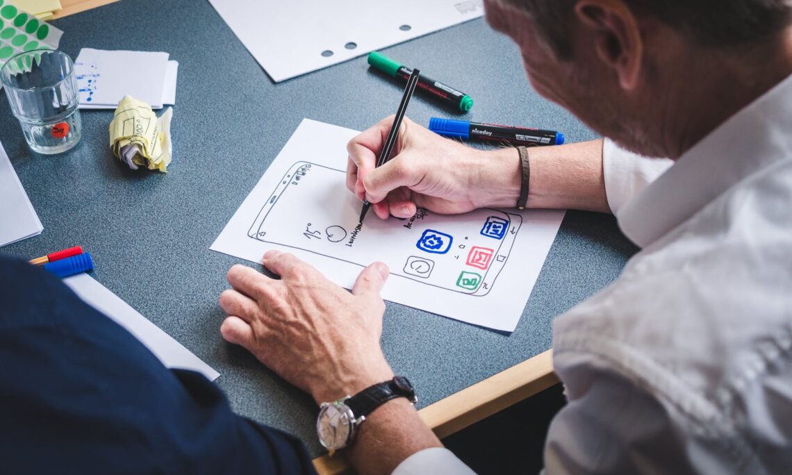 person writing on white paper