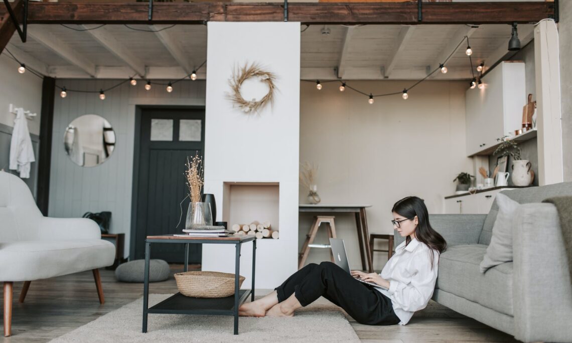 woman sitting on the floor using a laptop