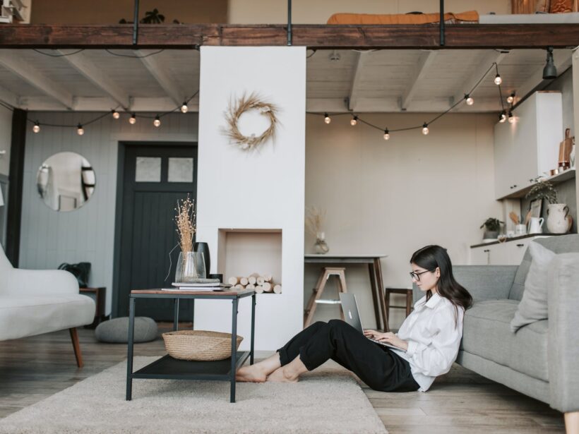 woman sitting on the floor using a laptop